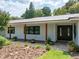 Exterior view of home featuring dark wood pillars and an elegant front entry at 3808 Gaines Dr, Winter Haven, FL 33884