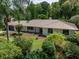 Charming house with metal roof, lush landscaping and a long driveway at 3808 Gaines Dr, Winter Haven, FL 33884