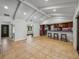 Open kitchen featuring bar seating and a wine fridge, with beamed ceilings and tile floors at 3808 Gaines Dr, Winter Haven, FL 33884