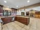 Spacious kitchen next to the living room with a stone fireplace that creates a cozy ambiance at 3808 Gaines Dr, Winter Haven, FL 33884