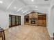 Living room featuring beamed ceiling, stone fireplace, built-ins, and tile flooring at 3808 Gaines Dr, Winter Haven, FL 33884