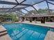 A refreshing pool offers a serene escape with lush landscaping and a screened enclosure at 3808 Gaines Dr, Winter Haven, FL 33884