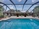 A large screened-in pool, perfect for relaxation and entertainment, with outdoor bar in background at 3808 Gaines Dr, Winter Haven, FL 33884