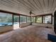 Relaxing screened porch with tiled floor overlooks the pool and lush landscaping at 3808 Gaines Dr, Winter Haven, FL 33884