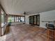 Spacious screened porch with tile flooring, white walls, and a ceiling fan at 3808 Gaines Dr, Winter Haven, FL 33884