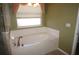 Relax in this garden tub with a large window at 3832 Traditions N Blvd, Winter Haven, FL 33884