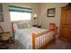 Cozy guest bedroom with wood frame bed and soft textiles at 3832 Traditions N Blvd, Winter Haven, FL 33884