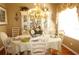 Formal dining room featuring a chandelier, decorative china cabinet, and elegant table setting at 3832 Traditions N Blvd, Winter Haven, FL 33884
