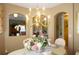 Bright dining room with a chandelier, decorative centerpiece, and access to the kitchen at 3832 Traditions N Blvd, Winter Haven, FL 33884
