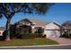 Attractive one-story home with a landscaped yard and a two-car garage at 3832 Traditions N Blvd, Winter Haven, FL 33884