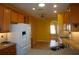 Kitchen boasts wood cabinets, granite countertops, and white appliances at 3832 Traditions N Blvd, Winter Haven, FL 33884