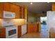 Kitchen with wood cabinets, granite countertops and white appliances at 3832 Traditions N Blvd, Winter Haven, FL 33884