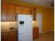 Kitchen with wood cabinets, granite countertops and white appliances at 3832 Traditions N Blvd, Winter Haven, FL 33884