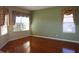 Bright living room featuring hardwood floors and large windows at 3832 Traditions N Blvd, Winter Haven, FL 33884