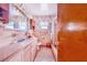 Bathroom with pink tile, a shower/tub combo, and vanity at 605 Florida Ave, Dundee, FL 33838