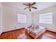 Bedroom with hardwood floors and two windows with blinds at 605 Florida Ave, Dundee, FL 33838