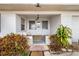 Quaint front porch entryway with brick flooring and potted plants at 605 Florida Ave, Dundee, FL 33838