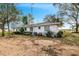 White single story house with a large yard at 605 Florida Ave, Dundee, FL 33838