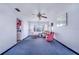 Living room with hardwood floors, a ceiling fan and a view into the kitchen at 605 Florida Ave, Dundee, FL 33838