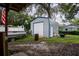 Metal storage shed with roll-up door and additional storage at 623 W Shady Ln, Lakeland, FL 33803