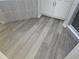 Bathroom with tiled shower, wood-look flooring, and modern vanity at 991 First Dr, Eagle Lake, FL 33839