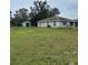 Spacious backyard with a storage shed and rear view of the single-story home at 720 S Morrison Ave, Fort Meade, FL 33841