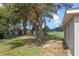 Lawn area, shade trees and play set in large grassy backyard at 720 S Morrison Ave, Fort Meade, FL 33841