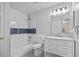 Bright bathroom featuring a shower-tub combo, white vanity with marble top, and blue-tiled backsplash at 720 S Morrison Ave, Fort Meade, FL 33841