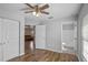 Bedroom showcasing wood-look floors and neutral walls, open to the bathroom and living room at 720 S Morrison Ave, Fort Meade, FL 33841