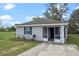 Charming single-story home with a well-maintained lawn and beautiful landscaping at 720 S Morrison Ave, Fort Meade, FL 33841