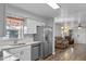 Bright kitchen with stainless steel appliances, white cabinets, and quartz countertops at 720 S Morrison Ave, Fort Meade, FL 33841