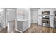Open kitchen layout with stainless steel appliances and access to the living area at 720 S Morrison Ave, Fort Meade, FL 33841