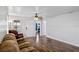 Bright living room featuring wood-look floors, ceiling fan, and neutral wall color at 720 S Morrison Ave, Fort Meade, FL 33841