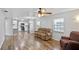 Open living room showcasing wood-look floors, seamlessly connecting to kitchen and dining at 720 S Morrison Ave, Fort Meade, FL 33841
