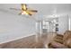 Open living room with wood-look floors seamlessly connects to the kitchen and dining area at 720 S Morrison Ave, Fort Meade, FL 33841