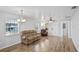 Inviting living room featuring wood-look flooring and a ceiling fan at 720 S Morrison Ave, Fort Meade, FL 33841