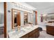 Double vanity bathroom with marble countertop and walk-in closet access at 524 Coleman W Dr, Winter Haven, FL 33884