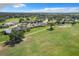 Scenic aerial view of the neighborhood showcasing golf course and mature trees at 579 Saint Andrews Rd, Winter Haven, FL 33884