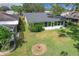 Aerial view of the back of the house with a lawn, landscaping, and a screened-in porch at 579 Saint Andrews Rd, Winter Haven, FL 33884