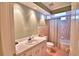 Well-lit bathroom featuring a single sink vanity and a tub with shower at 579 Saint Andrews Rd, Winter Haven, FL 33884