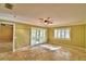 Spacious bedroom featuring shuttered windows, ceiling fan, with sliding glass doors leading to the outside at 579 Saint Andrews Rd, Winter Haven, FL 33884