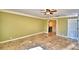 A well lit room with tiled flooring in the shape of a sun, ceiling fan, with a bathroom in view at 579 Saint Andrews Rd, Winter Haven, FL 33884