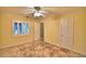 Neutral bedroom offers a ceiling fan, tile flooring, and exterior window with blinds at 579 Saint Andrews Rd, Winter Haven, FL 33884