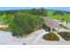 Aerial view of the clubhouse with manicured grounds, a well-maintained parking lot, and a glimpse of the surrounding golf course at 579 Saint Andrews Rd, Winter Haven, FL 33884