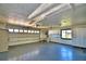 View of the spacious garage with a painted floor, built-in cabinets, and overhead lighting at 579 Saint Andrews Rd, Winter Haven, FL 33884