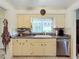 Kitchen area featuring sink, cabinetry, and stainless steel dishwasher at 579 Saint Andrews Rd, Winter Haven, FL 33884