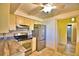 Kitchen featuring stainless steel refrigerator, range, and tile flooring at 579 Saint Andrews Rd, Winter Haven, FL 33884