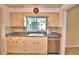 Kitchen sink area with stainless steel dishwasher and cabinets at 579 Saint Andrews Rd, Winter Haven, FL 33884