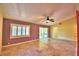 Spacious living room featuring neutral tile floors, a ceiling fan, and a large window at 579 Saint Andrews Rd, Winter Haven, FL 33884