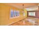 Bright living room with neutral tile flooring, shutters, and decorative pendant lighting at 579 Saint Andrews Rd, Winter Haven, FL 33884